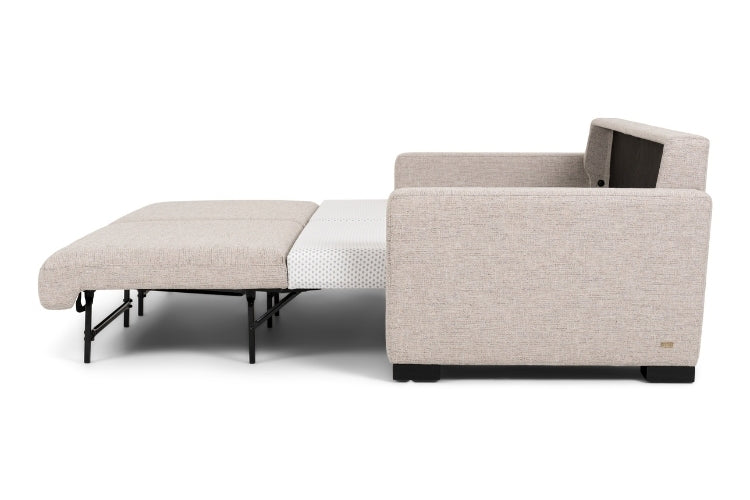 Beige sectional sofa bed pulled out to full size showing white mattress. 
