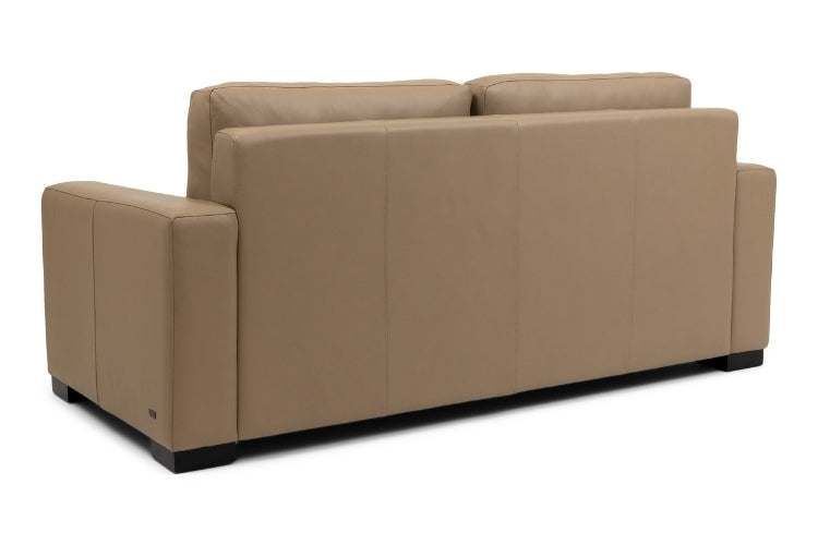 back view of tan sofa on a white background
