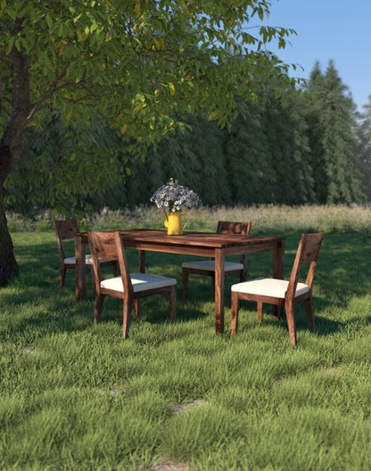 Rustic Walnut Dining Table in outdoor setting with chairs and decor