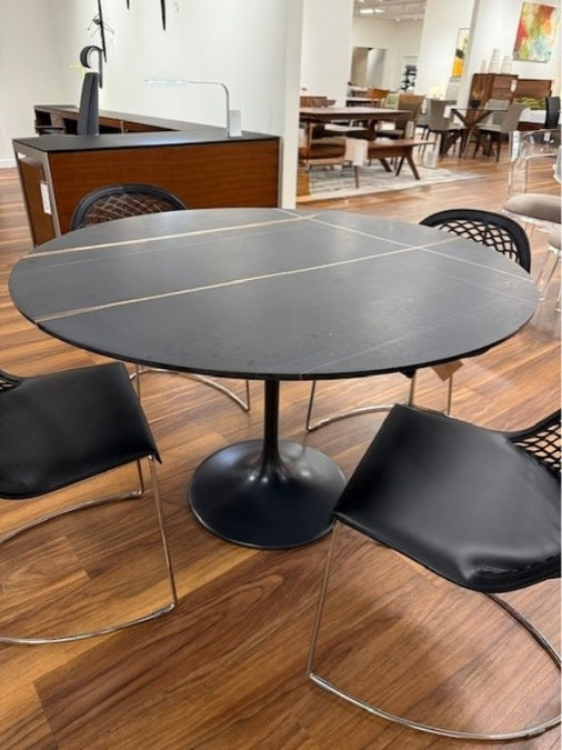 Flute Dining Table by Stone International is featured in Sahara Noir stone finish.