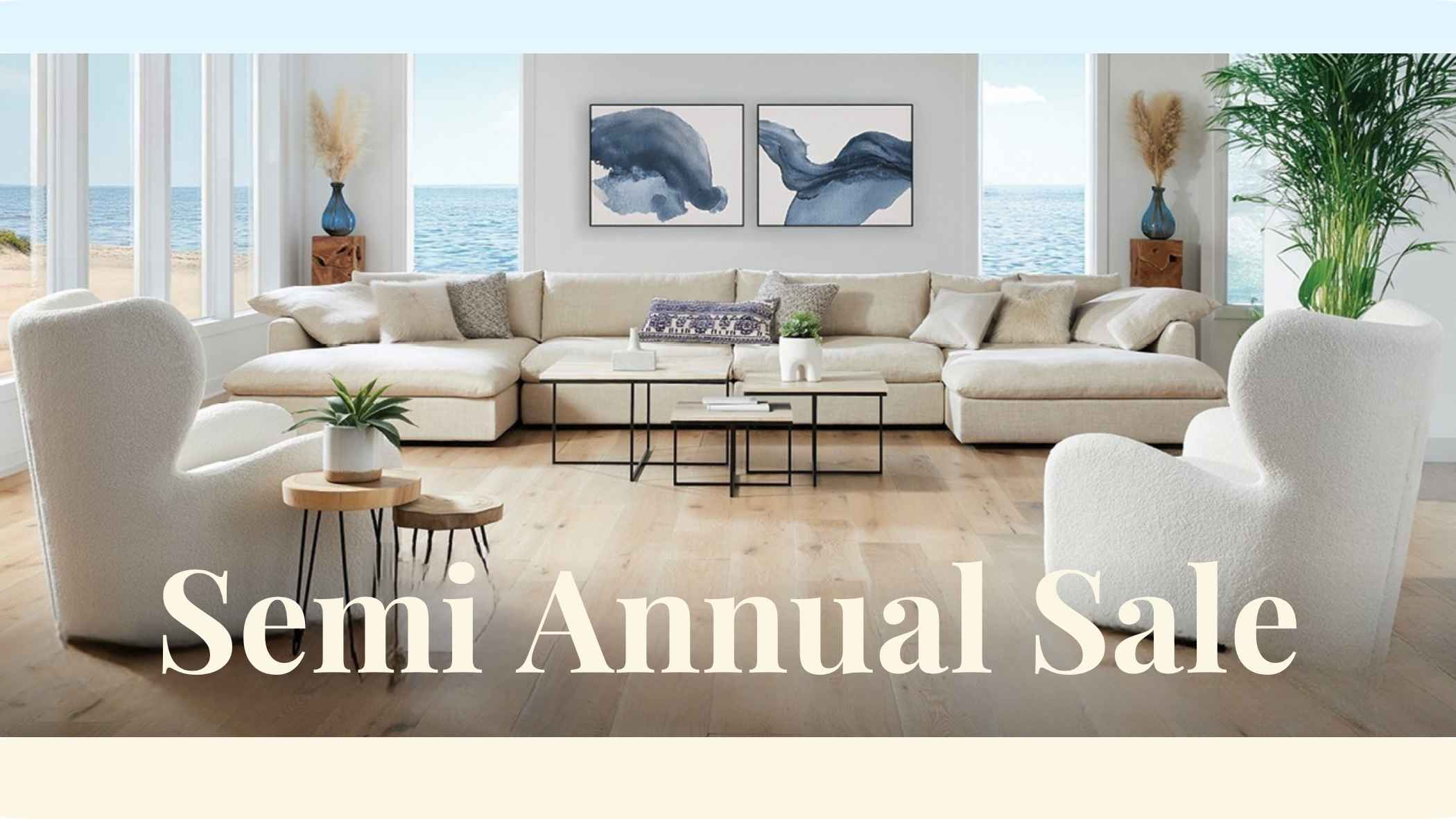 American Leather living room with a large sectional sofa, two white armchairs, a glass coffee table, and ocean views through tall windows. Large text across the bottom reads 'Semi Annual Sale'.