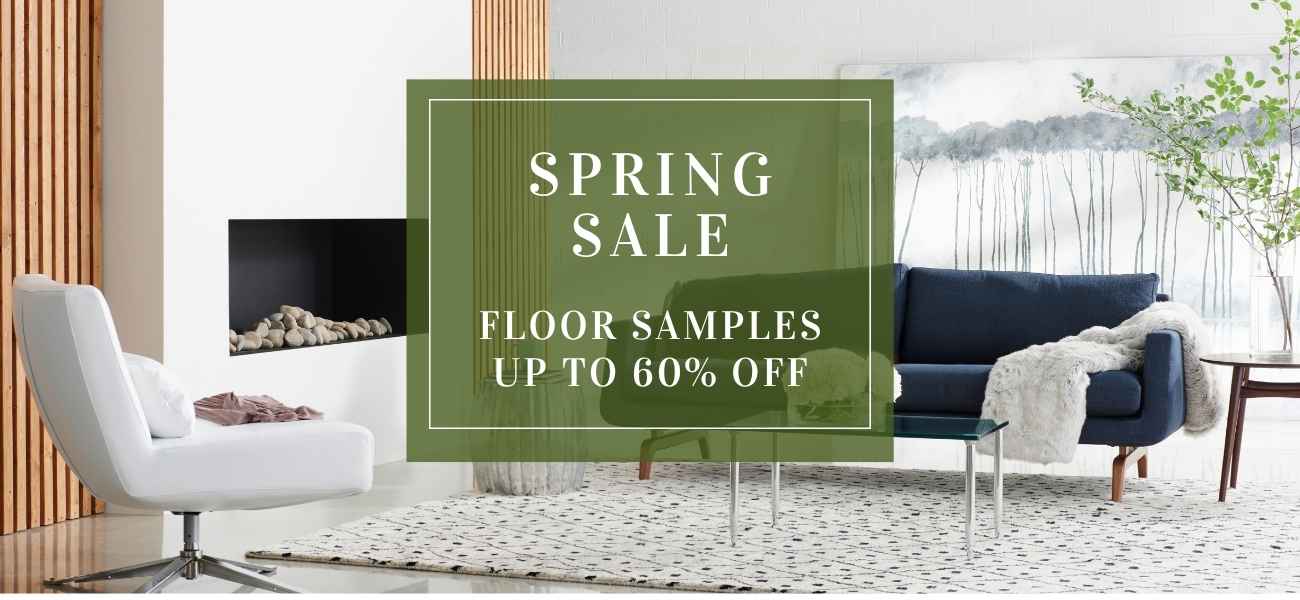 Living room with furniture and a 'Spring Sale' sign for floor samples.