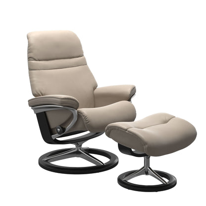 Mushroom colored sunrise recliner with matching ottoman featuring a curved base in metal and black