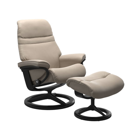 Mushroom colored sunrise recliner with matching ottoman featuring a curved base in metal and black