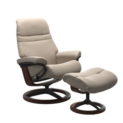 Mushroom colored sunrise recliner with matching ottoman featuring a curved base in metal and brown