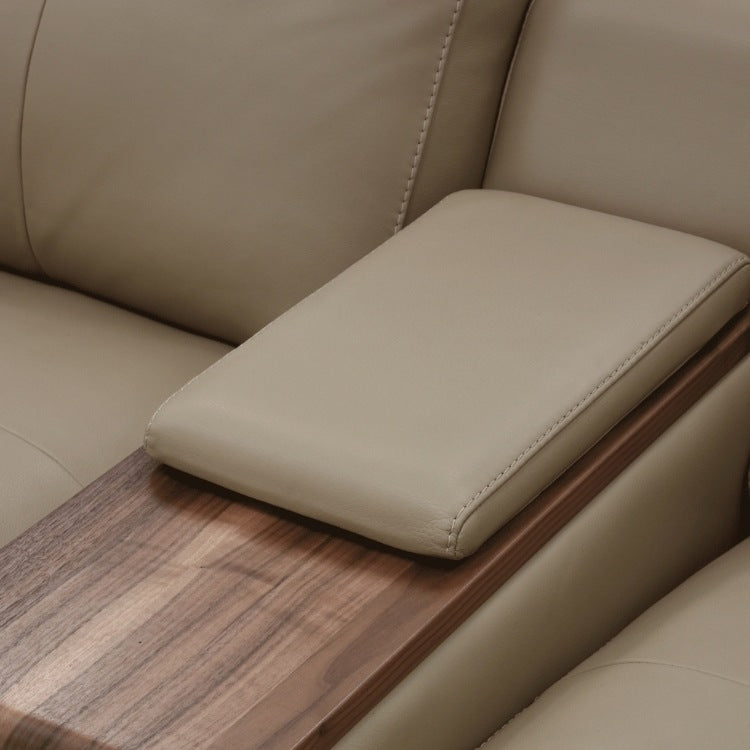 Beige leather sofa with a wooden armrest