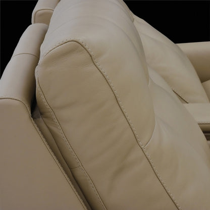 Close-up of beige leather theater seating showing pillow area for headrest 