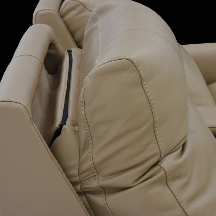 Close-up of beige leather theater seats with headrest in up position 