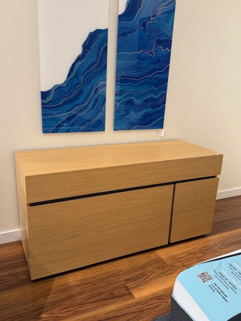 Wooden double dresser cabinet with a blue abstract painting  on the wall