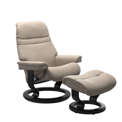 Beige colored sunrise recliner with matching ottoman both featuring a circular base in black wood.