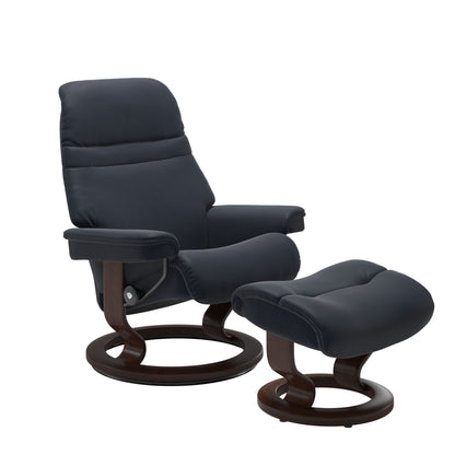 Shadow Blue colored sunrise recliner with matching ottoman both featuring a circular base in brown wood.