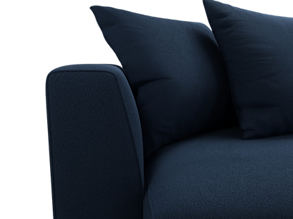 Close up of armrest and pillows on navy blue sofa