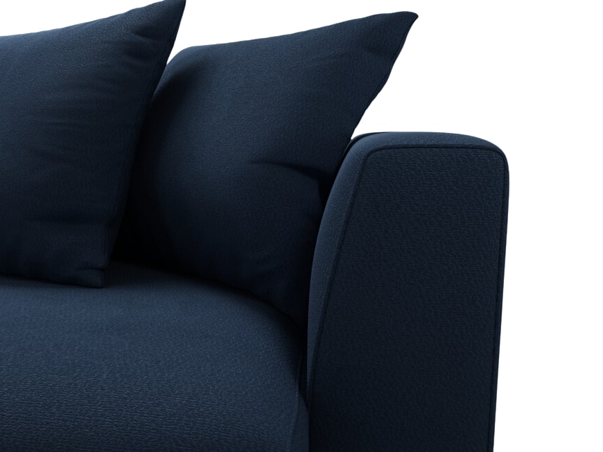 Close up of armrest and pillows on navy blue sofa