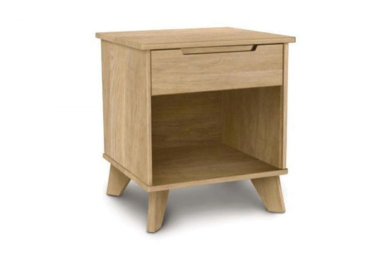Linn Wooden oak nightstand with one drawer, an open shelf, recessed handle and angled legs. 