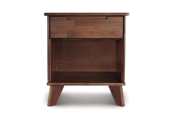Wooden walnut nightstand with one drawer, an open shelf, recessed handle and angled legs.