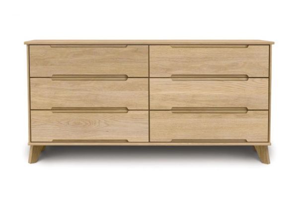 Oak wooden six drawer dresser with angled legs and recessed handles in mid century modern style.