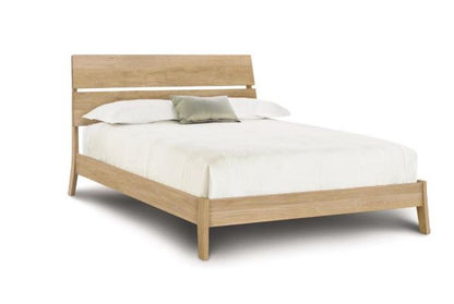 Linn Oak Platform Bed with slatted headboard,  and angled legs. 