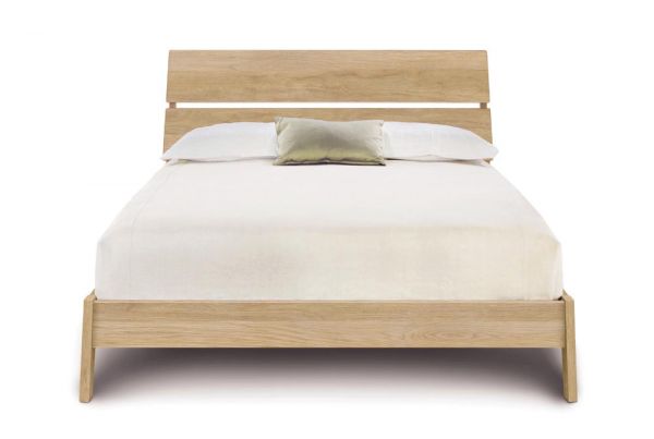 Linn Oak Platform Bed with slatted headboard,  and angled legs. 