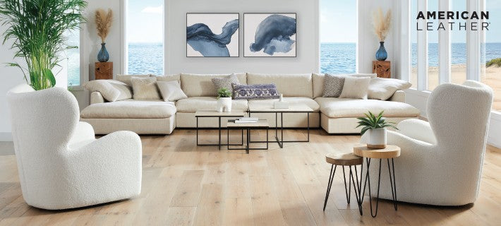 Modern living room with white sectional sofa, coffee table, and decor items.