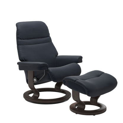 Shadow Blue colored sunrise recliner with matching ottoman both featuring a circular base in wenge wood.