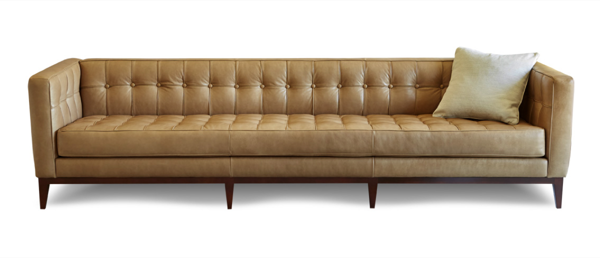 Gorgeous and Glamerous modern sofa boasts an Art Deco feel with a low-profile and tufted back, which is contrasted by a solid wood base in tan.