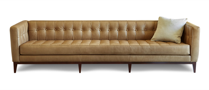 Gorgeous and Glamerous modern sofa boasts an Art Deco feel with a low-profile and tufted back, which is contrasted by a solid wood base in tan.