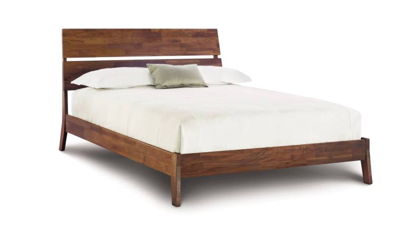Linn Walnut Platform Bed with slatted headboard,  and angled legs. 