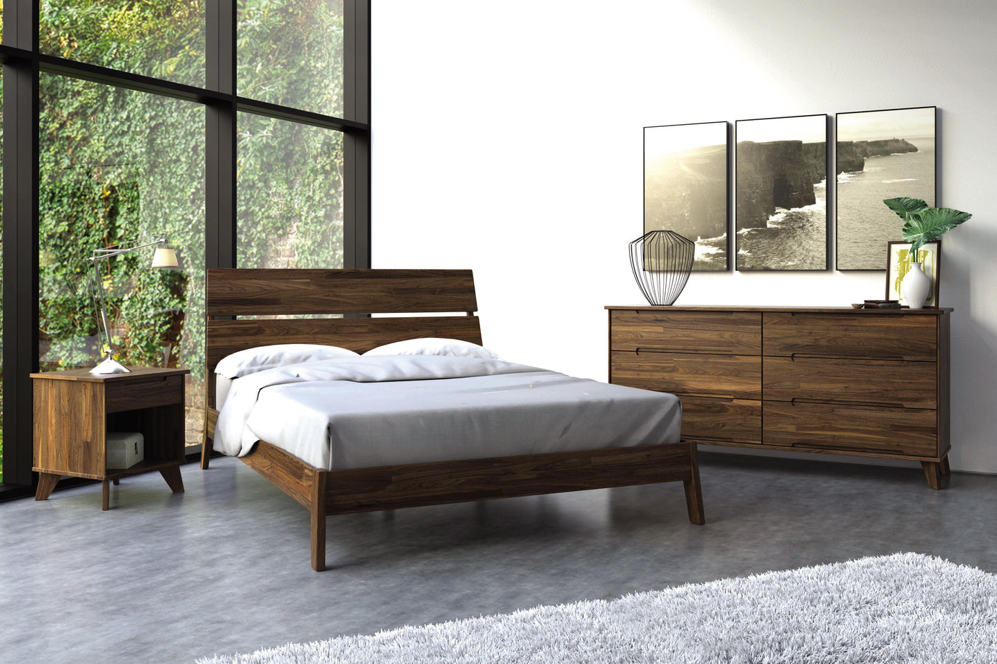 Linn Walnut Platform Bed with slatted headboard,  and angled legs between matching dresser and nightstand. 