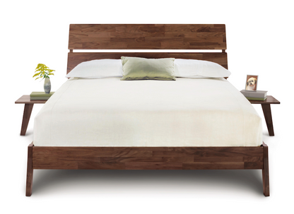 Front view Linn Platform Bed with slatted headboard,  and angled legs with 2 floating nightstands attached to either side of bed. 