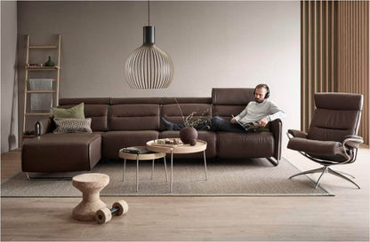 Stressless Emily 3 Seat Reclining Sofa in decorated room with man sitting and reading