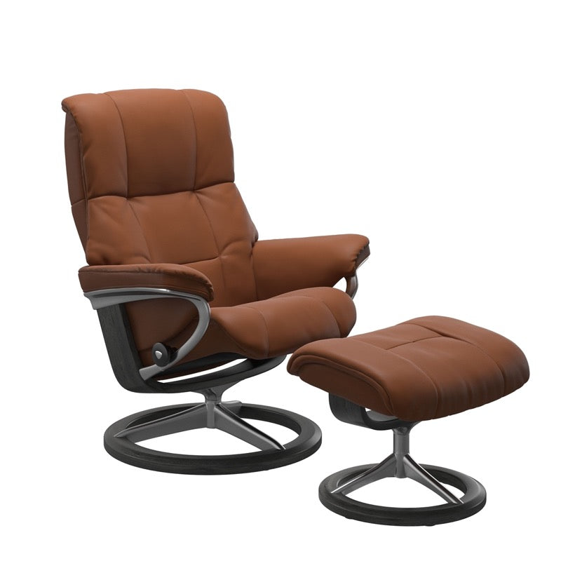 Luxurious  leather recliner in cognac color with a signature grey wood and adjustable ottoman 