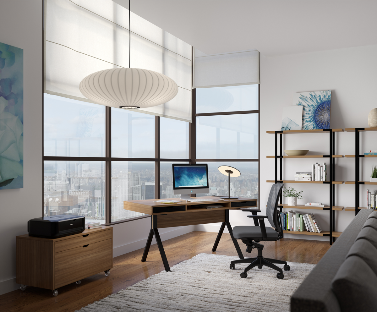 Home office and desk in front of a window with featured grey office chair 