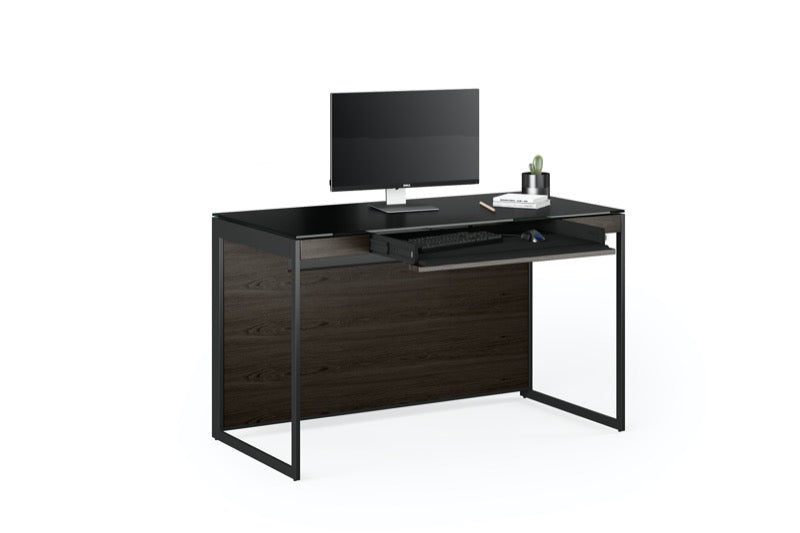 Front view of the Sequel 20 6103 Desk by BDI Furniture in Charcoal Stained Ash finish with a Laptop and books
