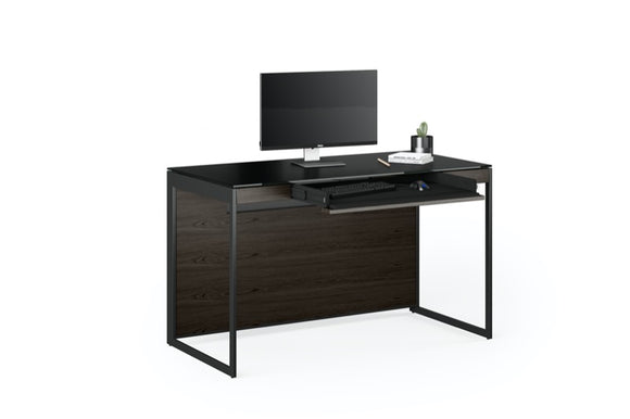 Front view of the Sequel 20 6103 Desk by BDI Furniture in Charcoal Stained Ash finish with a Laptop and books