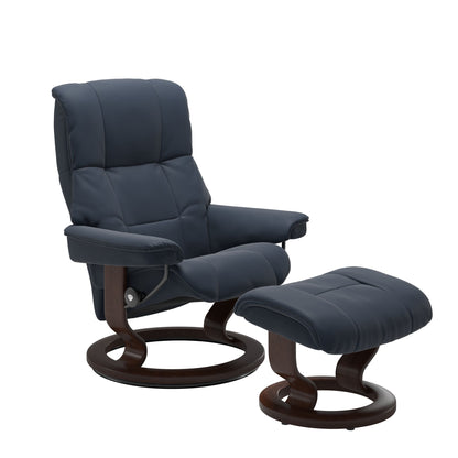 Luxurious  leather recliner navy blue colored with a brown wood classic base and adjustable ottoman