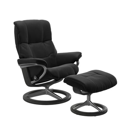Paloma black colored reclining chair with matching ottoman, both featuring padded cushions and grey circular base.