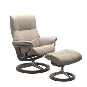 Luxurious  leather recliner in Paloma Fog color with a signature round base with walnut wood and adjustable ottoman  