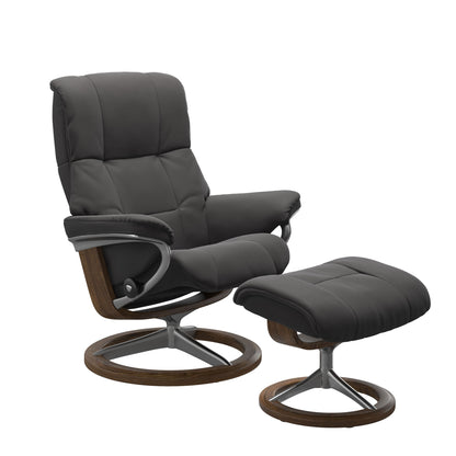 Luxurious leather recliner in dark grey color with a signature teak wood and adjustable ottoman.