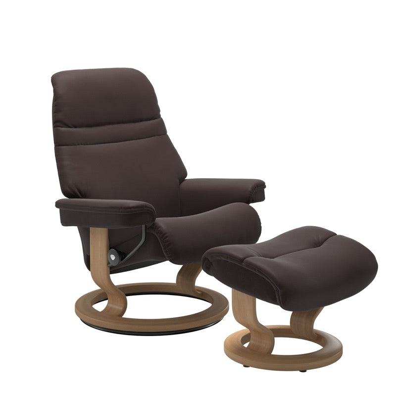 Chocolate colored sunrise recliner with matching ottoman both featuring a circular base in oak wood. 