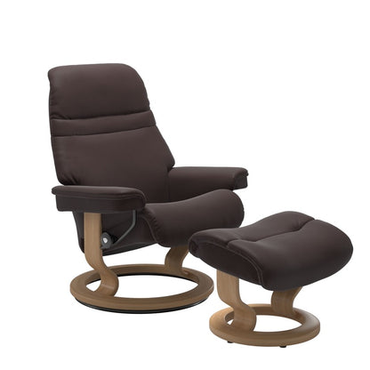 Chocolate colored sunrise recliner with matching ottoman both featuring a circular base in oak wood 