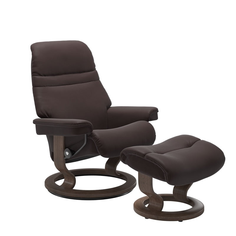 Chocolate colored sunrise recliner with matching ottoman both featuring a circular base in walnut wood.