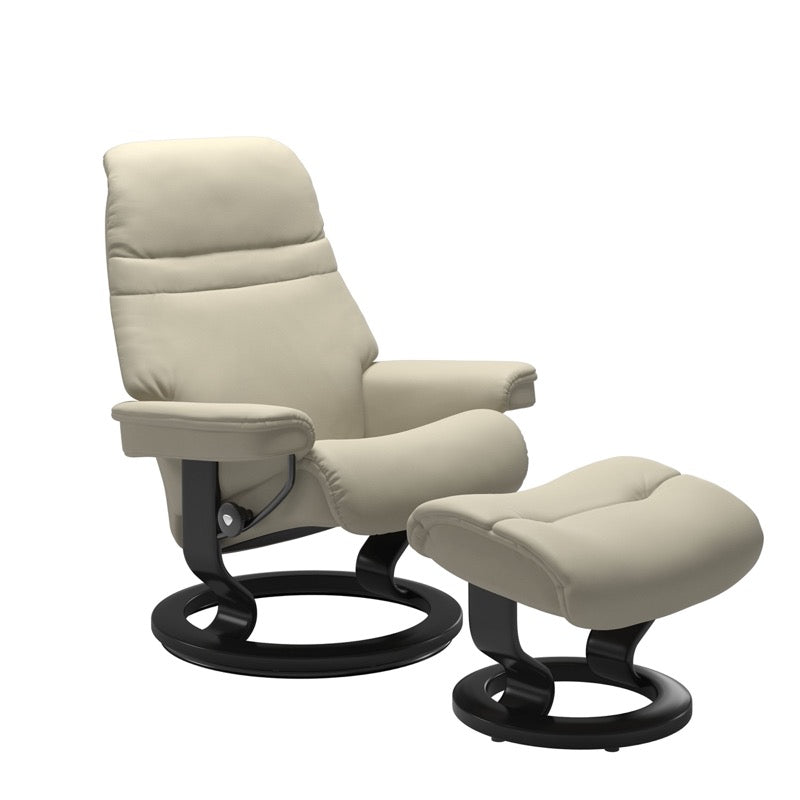 Light Grey colored sunrise recliner with matching ottoman both featuring a circular base in black wood. 
