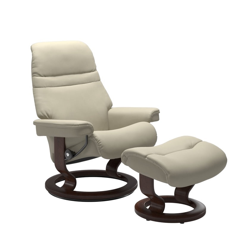 Light Grey colored sunrise recliner with matching ottoman both featuring a circular base in brown wood 