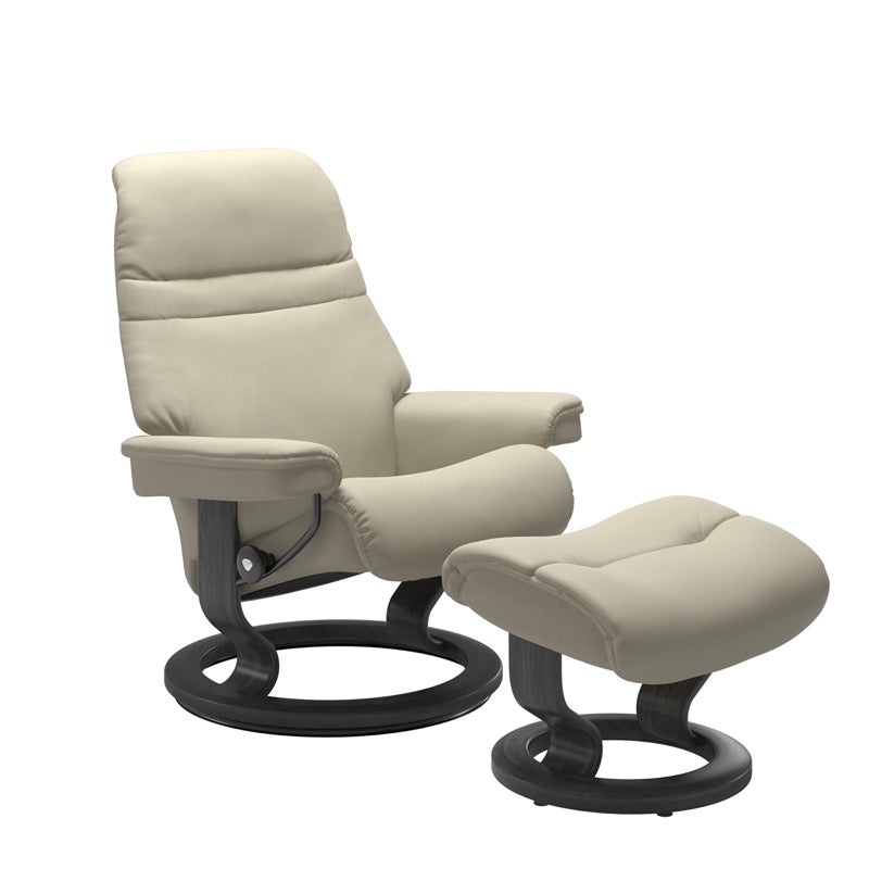 Light Grey colored sunrise recliner with matching ottoman both featuring a circular base in grey wood. 