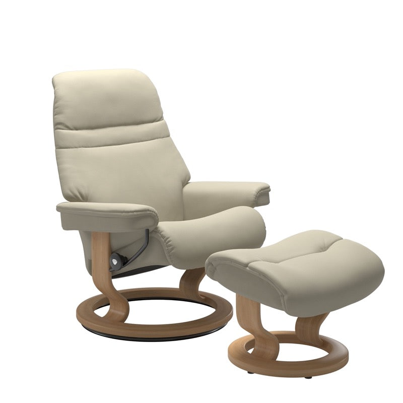 Light Grey colored sunrise recliner with matching ottoman both featuring a circular base in oak wood. 