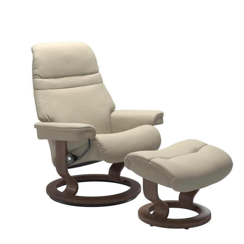 Light Grey colored sunrise recliner with matching ottoman both featuring a circular base in walnut wood 