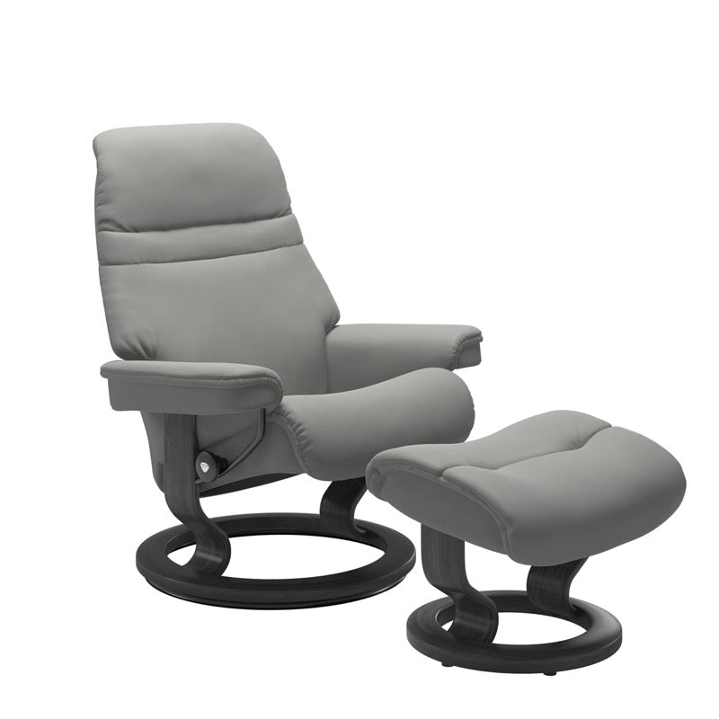 Silver grey colored sunrise recliner with matching ottoman both featuring a circular base in grey wood.