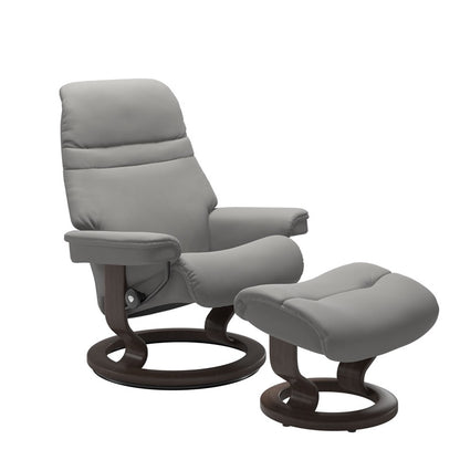 Silver grey colored sunrise recliner with matching ottoman both featuring a circular base in wenge wood 