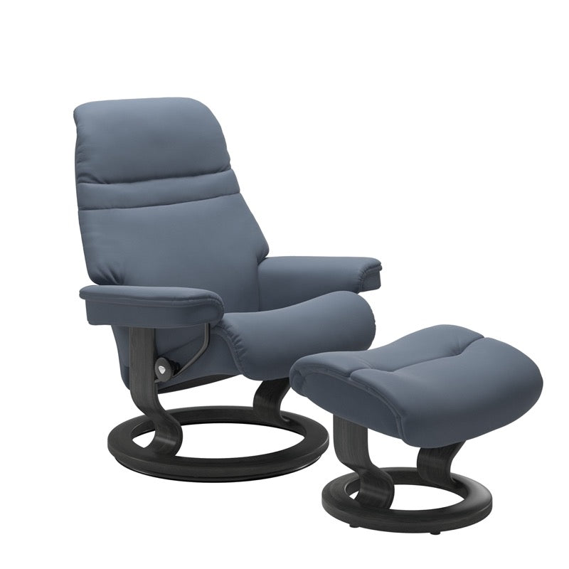 Sparrow Blue colored sunrise recliner with matching ottoman both featuring a circular base in grey wood. 