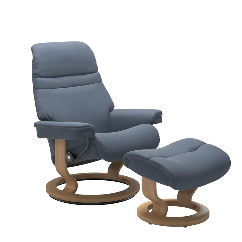 Sparrow Blue colored sunrise recliner with matching ottoman both featuring a circular base in oak wood. 